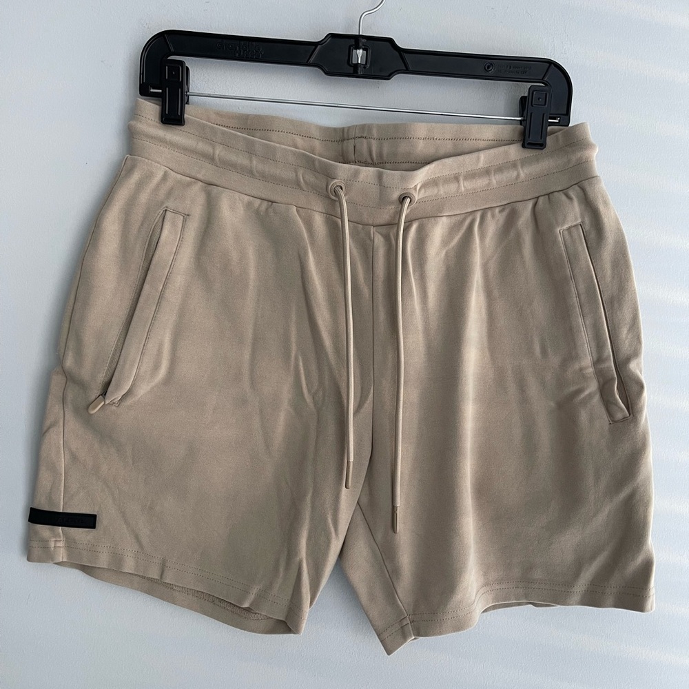 Alphalete Cream Shorts with Black Logo Patch